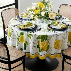 the table is set with lemons and plates