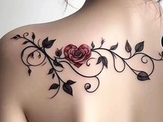 the back of a woman's shoulder with roses and leaves tattoo on her chest