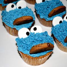 some cupcakes with blue frosting and googly eyes