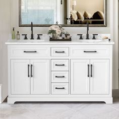 a bathroom vanity with two sinks and a large mirror