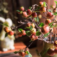 an apple tree in a vase on a table