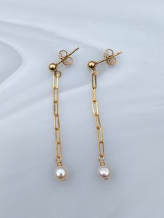 A lovely pair of gold stud earrings with a freshwater pearl on the end of a paperclip chain these are lightweight and perfect for any occasion, these would make a great gift for a loved one. - Made From: 14k Gold Fill - Gemstone: Freshwater Pearls , roughly 3-4mm in size - Drop Length - Paperclip chain. Drop length with pearl roughly 3.5cm. On a stud earring. As they are handmade please note pieces will never have the same finish as machine made/mass produced.  Each one is unique. What is Gold Fill  - Gold Filled Jewellery is a thick layer of Real solid 14k Gold bonded over a base Metal of sterling silver or brass.  - Gold Fill will not tarnish and will never reveal the base layer - it is hypoallergenic  - if looked after well Gold Fill jewellery pieces can last a life time.   - stamped wi Minimalist Earrings With Paperclip Chain As Gift, Minimalist Paperclip Chain Earrings As Gift, Minimalist Paperclip Chain Earrings For Gift, Gold Earrings With Paperclip Chain For Gift, Elegant Cable Chain Earrings As Gift, Elegant Paperclip Earrings With Ear Wire, Elegant Paperclip Shape Earrings With Ear Wire, Classic Gold Earrings With Paperclip Chain, Elegant Everyday Earrings With Paperclip Chain