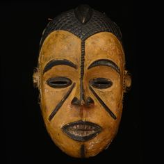 an african mask is shown against a black background