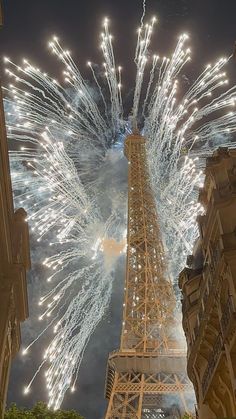 the eiffel tower is lit up with fireworks