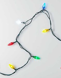 a string of christmas lights on a white surface