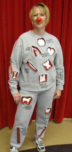 a woman in grey pajamas with red nose and nose rings