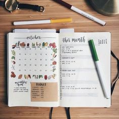 an open planner book sitting on top of a wooden table