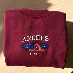 *SIZES ARE UNISEX* -I'd suggest your usual size for a more fitted look, or sizing up for a more relaxed fit. *these sweatshirts are extra comfy when oversized "Arches Utah" embroidered on a comfy cute vintage-style crewneck. A sturdy and warm sweatshirt bound to keep you warm in the colder months. A pre-shrunk, classic fit sweater that's made with air-jet spun yarn for a soft feel and reduced pilling. Your new favorite sweatshirt! * 50% cotton, 50% polyester * Pre-shrunk * Classic fit with no ce Arches Utah, Utah Outfits, National Park Sweatshirt, Vintage Crewneck Sweatshirt, Vintage Crewneck, Embroidered Crewneck, Arches National Park, Fashion Wishlist, Clothing Hacks