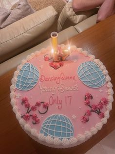 a birthday cake with candles on it sitting on a table