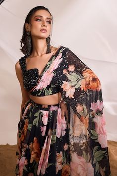 Black draped skirt with multi colored floral prints. Comes with coordinating printed and embellished blouse with shoulder drape. - Aza Fashions Floral Print Dress With Traditional Drape For Party, Multicolor Sequin Georgette Dresses, Elegant Cape, Draped Blouse, Black Drapes, Draped Skirt, Embellished Blouse, Cape Sleeves, Floral Print Skirt