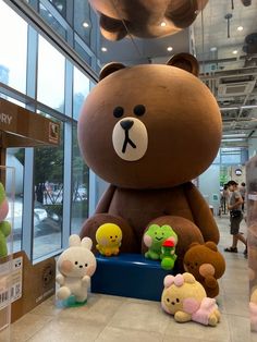 a large teddy bear surrounded by smaller stuffed animals