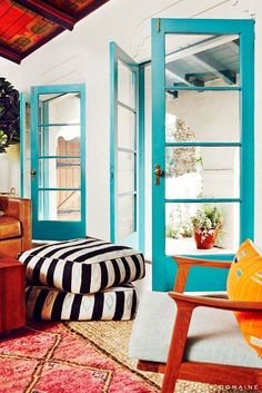 a living room filled with furniture and blue doors