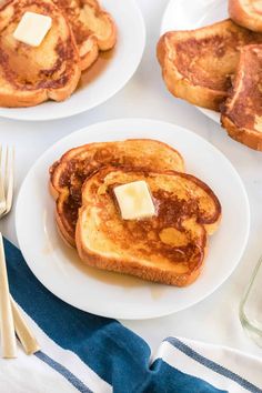 pancakes with butter and syrup on white plates