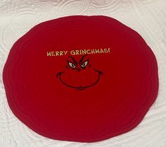 a red frisbee with the words merry grinmas on it and an angry face