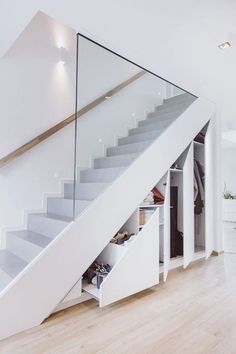 a white staircase with drawers underneath it