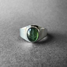 Natural Green Tourmaline Silver Ring - Green Chrome Tourmaline Ring Size 7 - Completely Handmade & Silver Gemstone: Green Tourmaline ( Chrome Tourmaline )  Metal: Pure and 925 Sterling Silver Stone Cut: Cabochon Stone Size: 8.5 mm x 6.9 mm - 0.33 in - 0.27 in Weight: 4.6 grams (23 carats) total weight of stone and silver. For ring orders, ring resizing is free. Chains are gifts for necklace orders..  Note: We don't use any filters for photos. The details may not be clear. Feel free to contact us Classic Tourmaline Jewelry With Polished Finish, Silver Tourmaline Rings For Formal Occasions, Fine Jewelry Green Tourmaline Gemstones, Green Tourmaline Gemstones For Fine Jewelry, Polished Tourmaline Round Ring, Polished Tourmaline Jewelry For Anniversary, Polished Tourmaline Rings, Classic Oval Tourmaline Emerald Ring, Formal Tourmaline Birthstone Jewelry