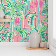 a pink and green wallpaper with palm trees on it