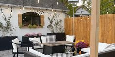 an outdoor seating area with patio furniture and string lights