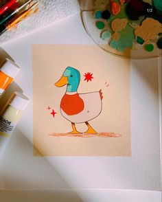 a drawing of a duck on paper next to some markers