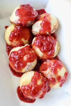 small pastries with strawberry jam in a white box