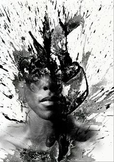 a woman's face with splashing paint on it and the image is black and white