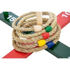 a close up of a rope on top of a red and green measuring tape with an object in the middle