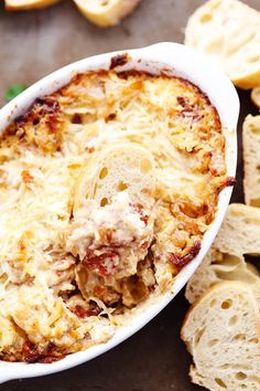 a casserole dish with cheese and bread slices on the side, ready to be eaten