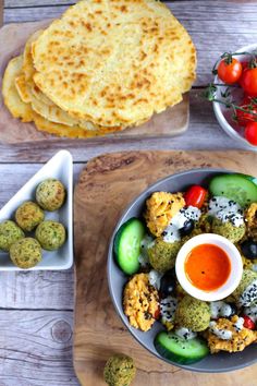 a bowl filled with vegetables next to some pita bread