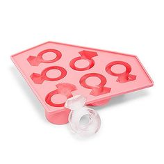 a pink ice tray with various shapes and sizes on it, including an o - ring