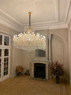 a chandelier hanging from the ceiling in a living room