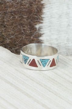 This turquoise and coral chip inlay sterling silver ring was made by Navajo silversmith Raymond Begay. The inside is signed and stamped sterling.Size: 13.25Length: 3/8"Width: 1"Free shipping on all orders! We ship with USPS and always include tracking. All orders ship within a day of payment.Returns are accepted up to 30 days after you receive your order. Just send us a message. Our shop offers cash back or store credit. The item must be returned in new condition. Southwestern Inlay Jewelry For Anniversary, Southwestern Style Inlay Jewelry For Anniversary, Red Sterling Silver Ring With Inlay, Red Sterling Silver Rings With Inlay, Southwestern Style Rings With Inlay As Gift, Bohemian Turquoise Ring With Inlay For Anniversary, Southwestern Style Rings With Inlay For Gift, Bohemian Turquoise Inlay Ring For Anniversary, Adjustable Southwestern Red Rings