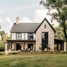 a large house sitting on top of a lush green field