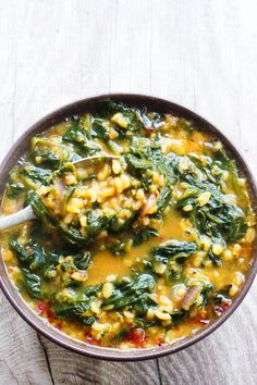 a bowl filled with soup on top of a wooden table