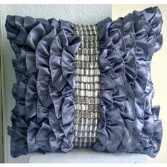 a decorative pillow with ruffled edges on a wall