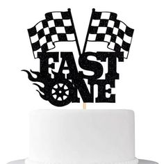 a cake topper that says fast and one with checkered flags on the top