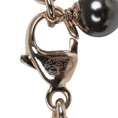 This Chanel necklace features a reversible Black glitter enamel heart charm with the classic CC motif on the front and a crystal embellished CC heart charm design on the reverse side. The chain is silver tone in a Rolo design with 6 black beads and faux crystals near the heart charm. The necklace features a lobster claw closure. Origin: France Condition: New and never worn Accompanied by: Chanel box and pouch, retail UPC Measurements: Chain 9" Pendant .75" x .75" Luxury Silver Necklace With Black Enamel, Classic Metal Jewelry With Logo Charm, Luxury Metal Jewelry With Removable Charms, Luxury Metal Jewelry With Logo Charm, Elegant Pendant Charms With Logo, Elegant Pendant Logo Charm, Elegant Metal Charms With Removable Feature, Elegant Logo Charm Pendant, Luxury Heart Pendant Jewelry With Lobster Clasp