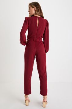 The Lulus In the City Burgundy Surplice Long Sleeve Jumpsuit is a look that can take you where you wanna go! Lightweight flat woven fabric sweeps chicly across long sleeves and a flirty surplice bodice with pleated detail and a back keyhole (secured by two round covered buttons). Paper bag waist (with belt loops and a tying sash belt) adds unique flair atop slim cropped pant legs, making this jumpsuit a stylish choice for day or night! Hidden side seam pockets. Hidden back zipper/clasp. Fit: Thi Chic Long Sleeve Jumpsuits And Rompers For Fall, Elegant Long Sleeve Jumpsuits And Rompers For Fall, Long Sleeve Jumpsuits For Date Night In Fall, Elegant Winter Jumpsuits And Rompers For Work, Elegant Winter Workwear Jumpsuits And Rompers, Long Sleeve Jumpsuits And Rompers For Work In Fall, Elegant Long Sleeve Winter Jumpsuits And Rompers, Elegant Winter Jumpsuits And Rompers With Long Sleeves, Winter Workwear Long Sleeve Jumpsuits And Rompers