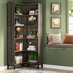 a corner bookcase in the corner of a room with green walls and pictures on the wall