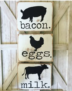 three wooden signs that say bacon, eggs, and milk with farm animals on them