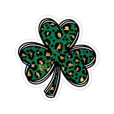 a shamrock shaped sticker sitting on top of a white surface