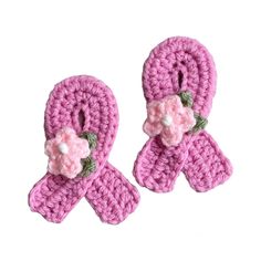 two pink crocheted bows with flowers on them