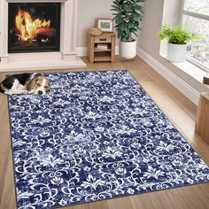 a dog laying on top of a blue rug in front of a fire place with a potted plant