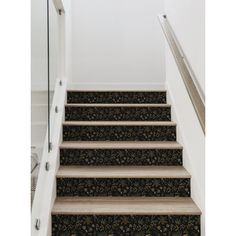 the stairs are decorated with black and gold wallpaper