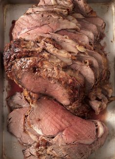 sliced meat in a metal pan on a table