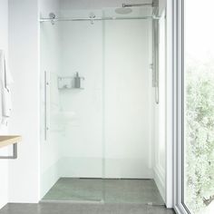 a bathroom with a walk in shower next to a window