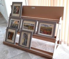 a display case with pictures on it in the middle of a tile flooring area