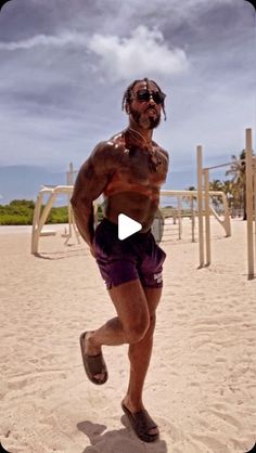 a man running on the beach with no shirt