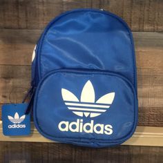 New!!!Adidas Original Santiago Mini Backpack.Collegiate Royal. 100% Polyester Imported Zipper Closure Clean With Damp Cloth As Necessary Screen-Printed Branding Nylon Zippers Interior Woven Label Branding Main Compartment With Pocket Front Pocket With Key Fob For Smaller Items Description Purse-Size Capacity, Hands-Free Convenience. This Little Pack Is Just Right For Stashing The Essentials. A Key Fob Is Tucked Inside The Front Pocket Where You'll Always Be Able To Find It. Casual Adidas Logo Bags For Outdoor Activities, Adidas Streetwear Bag With Logo, Casual Adidas Logo Standard Backpack, Casual Adidas Backpack, Adidas Logo Backpack For Outdoor Activities, Adidas Logo Nylon Bags For Outdoor Activities, Casual Adidas Backpack With Logo, Casual Adidas Logo Bags For Everyday Use, Adidas Logo Backpack For Everyday Use