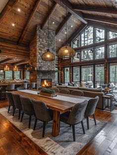 a large dining room table with chairs and a fire place in the middle of it