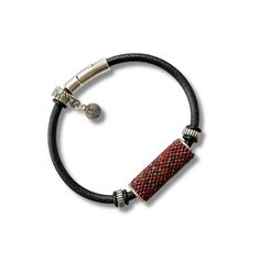 a black leather bracelet with red and silver beads